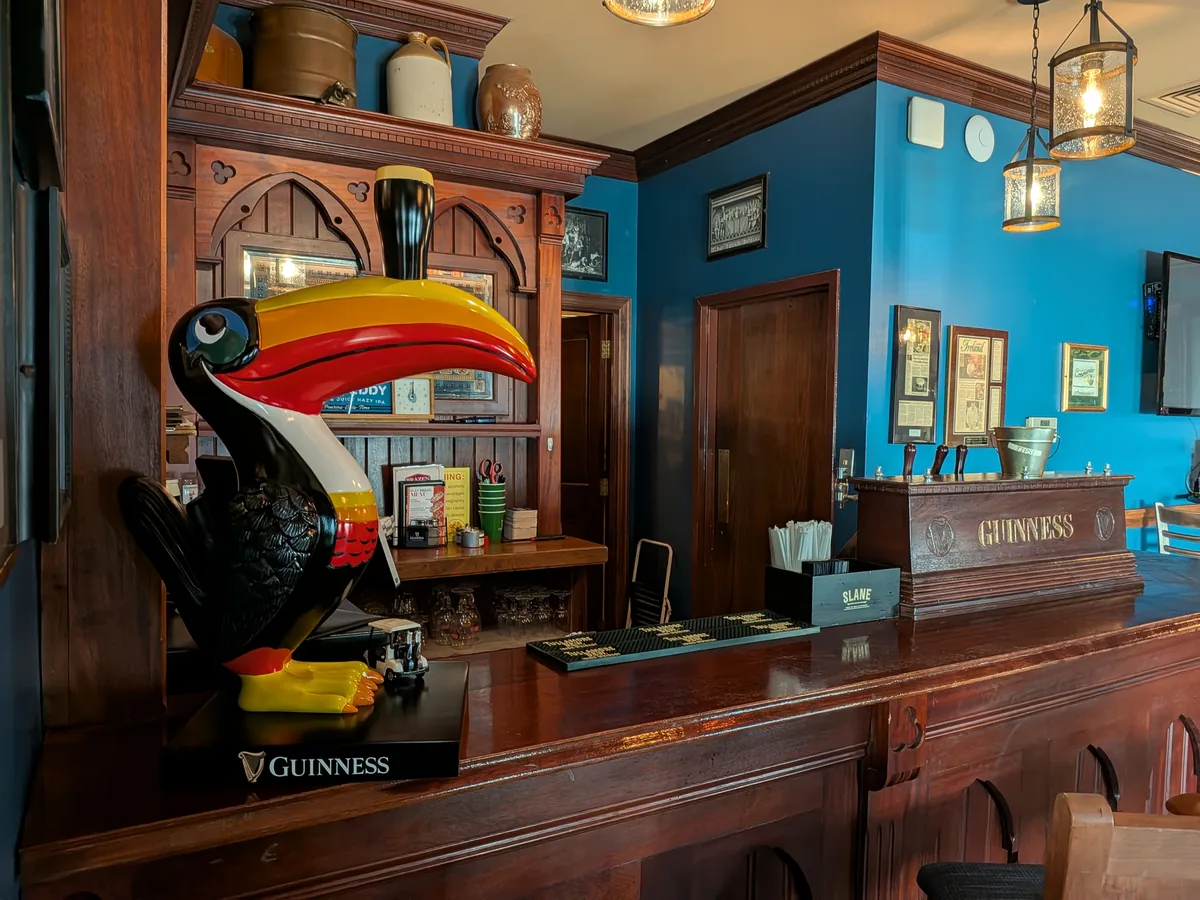 Wooden private bar with a Guinness toucan inside the Robert Emmet Room